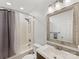 Updated bathroom with shower-tub combo, large mirror, and modern vanity lighting at 2214 Olde Chantilly Ct, Charlotte, NC 28205