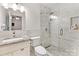 Modern bathroom with a glass-enclosed shower, granite vanity top, and tiled floors, creating a spa-like retreat at 2214 Olde Chantilly Ct, Charlotte, NC 28205