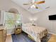 Bedroom with natural light, complemented by a ceiling fan, a television, and classic decor at 2214 Olde Chantilly Ct, Charlotte, NC 28205
