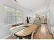 Well-lit dining area featuring an adjacent kitchen and a view of the outdoors through the large windows at 2214 Olde Chantilly Ct, Charlotte, NC 28205