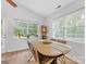 Sunlit dining room with a large window and an antique grandfather clock adding a touch of charm at 2214 Olde Chantilly Ct, Charlotte, NC 28205