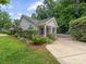 Charming home with a manicured lawn, colorful flower bushes and a spacious driveway at 2214 Olde Chantilly Ct, Charlotte, NC 28205