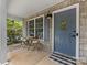 Cozy front porch with seating, stylish decor, and a welcoming entrance with a blue front door at 2214 Olde Chantilly Ct, Charlotte, NC 28205