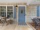 Inviting front porch with decor and stylish blue door, perfect for enjoying outdoor living at 2214 Olde Chantilly Ct, Charlotte, NC 28205
