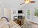 Comfortable living room featuring a fireplace, ceiling fan, and access to the outside, creating an inviting space at 2214 Olde Chantilly Ct, Charlotte, NC 28205