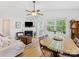 Bright living area with a fireplace, ceiling fan, and a round rug creating a cozy atmosphere at 2214 Olde Chantilly Ct, Charlotte, NC 28205
