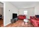 Cozy living room with hardwood floors, bright window, and comfortable seating at 2629 Vail Ave, Charlotte, NC 28204