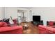 Spacious living area featuring hardwood floors, TV, and access to dining at 2629 Vail Ave, Charlotte, NC 28204