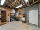 Unfinished basement space with utility shelving and an exterior door at 300 Boyd Rd, Clover, SC 29710