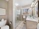 Modern bathroom with a glass-enclosed shower, vanity with marble countertop, and a bright window at 300 Boyd Rd, Clover, SC 29710