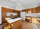 Well-lit kitchen with wooden cabinetry, an island cooktop, and ample counter space at 300 Boyd Rd, Clover, SC 29710