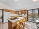 Bright kitchen with wooden cabinetry, an island cooktop, and a sliding glass door leading to a deck at 300 Boyd Rd, Clover, SC 29710