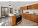 Bright kitchen featuring wood cabinets, stainless steel appliances, and a cozy eat-in area with large windows at 300 Boyd Rd, Clover, SC 29710
