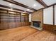 Spacious living room with a brick fireplace, wooden beams, hardwood floors, and built-in bookshelves at 300 Boyd Rd, Clover, SC 29710