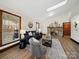 Cozy living room featuring a stone fireplace, comfortable seating, and natural light from large windows at 300 Boyd Rd, Clover, SC 29710