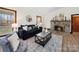 Warm living room with a stone fireplace, comfortable seating, and a neutral color palette at 300 Boyd Rd, Clover, SC 29710