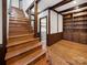 Charming living room featuring wooden beams, hardwood floors, and a view of the staircase and laundry room at 300 Boyd Rd, Clover, SC 29710