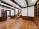 Inviting living room with hardwood floors, wooden beams, and an entrance to a cozy bedroom at 300 Boyd Rd, Clover, SC 29710