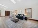 Bright living room with a decorative rug, stylish furniture, and large windows showcasing the outdoor view at 300 Boyd Rd, Clover, SC 29710