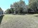Picture of a spacious, well-maintained backyard with mature trees and a white picket fence at 3007 Walsingham Ct, Matthews, NC 28105