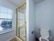 Bright bathroom features a glass-enclosed shower and a window at 3007 Walsingham Ct, Matthews, NC 28105