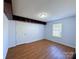 Bedroom featuring hardwood floors, a window, and built in storage space at 3007 Walsingham Ct, Matthews, NC 28105