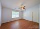 Bedroom featuring natural light, a ceiling fan, and wood-look floors at 3007 Walsingham Ct, Matthews, NC 28105