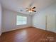 Bedroom featuring wood-look flooring, a ceiling fan, and natural light at 3007 Walsingham Ct, Matthews, NC 28105