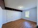 Bedroom featuring hardwood floors, a window, and built in storage space at 3007 Walsingham Ct, Matthews, NC 28105