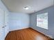 Cozy bedroom with hardwood floors, a window with blinds, and closet space at 3007 Walsingham Ct, Matthews, NC 28105
