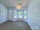 Bright dining area features a bay window, wood floors, and elegant chandelier at 3007 Walsingham Ct, Matthews, NC 28105