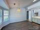 Cozy dining room with natural light from large windows and wood-look flooring at 3007 Walsingham Ct, Matthews, NC 28105