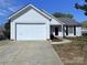 Charming single-story home with an attached two-car garage and a well-manicured front yard, perfect for curb appeal at 3007 Walsingham Ct, Matthews, NC 28105