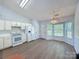 Bright kitchen features white cabinetry, modern appliances, and wood-look flooring at 3007 Walsingham Ct, Matthews, NC 28105