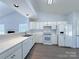 Well-lit kitchen featuring white countertops, ample cabinetry, and modern appliances for a functional cooking space at 3007 Walsingham Ct, Matthews, NC 28105