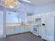 Bright eat in kitchen with white cabinets, modern appliances, and a serving hatch through to the living room at 3007 Walsingham Ct, Matthews, NC 28105