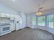 Bright kitchen features white cabinetry, modern appliances, and wood-look flooring at 3007 Walsingham Ct, Matthews, NC 28105