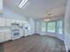 Bright kitchen features white cabinetry, modern appliances, and wood-look flooring at 3007 Walsingham Ct, Matthews, NC 28105