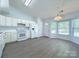 Bright kitchen featuring white appliances, ample cabinet space, and a bay window at 3007 Walsingham Ct, Matthews, NC 28105