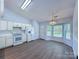 Bright kitchen features white cabinetry, modern appliances, and wood-look flooring at 3007 Walsingham Ct, Matthews, NC 28105