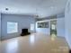 Open living room features a fireplace, plenty of natural light, ceiling fan and light wood floors at 3007 Walsingham Ct, Matthews, NC 28105