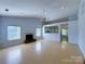 Spacious living room with hardwood floors, a fireplace, and natural light at 3007 Walsingham Ct, Matthews, NC 28105