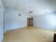 Open living room with ceiling fan and light wood floors at 3007 Walsingham Ct, Matthews, NC 28105