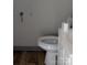 Clean and simple toilet in the bathroom with hardwood flooring at 301 Huffman Rd, Gastonia, NC 28056