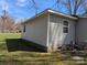 Side view of a quaint house with gray siding and green grass at 301 Huffman Rd, Gastonia, NC 28056
