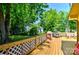 Inviting back deck with lattice railings, featuring a grill and dining area overlooking the backyard at 302 Griffith Rd, Monroe, NC 28112