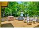 Spacious back deck featuring outdoor lounge furniture and dining, surrounded by lush greenery for outdoor enjoyment at 302 Griffith Rd, Monroe, NC 28112