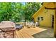 Relaxing back deck featuring an outdoor dining area and grill, perfect for entertaining and enjoying the outdoors at 302 Griffith Rd, Monroe, NC 28112