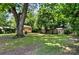 Spacious backyard featuring a shed, mature trees, and a well-maintained lawn, perfect for outdoor activities and relaxation at 302 Griffith Rd, Monroe, NC 28112