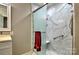Bathroom showcasing marble shower with glass door and safety handle at 302 Griffith Rd, Monroe, NC 28112